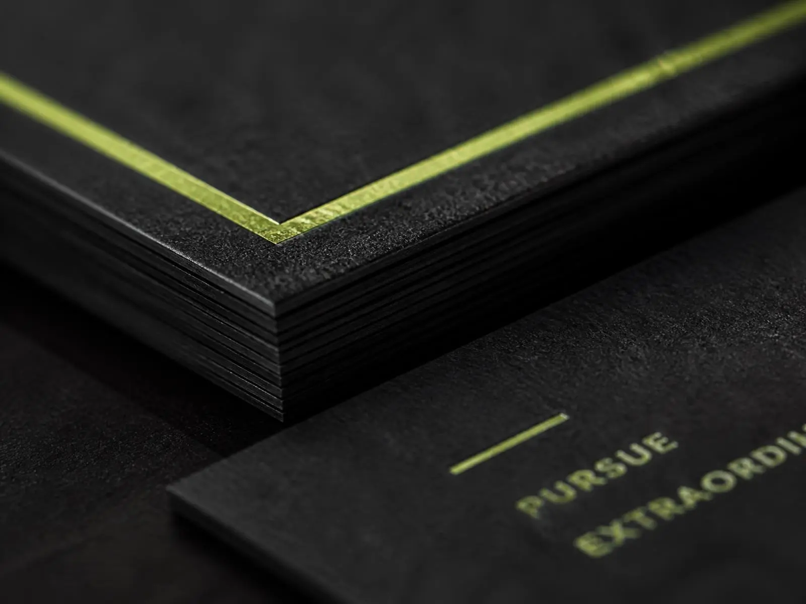 Macro photograph of thick cotton business cards with letterpress ink and foil detail